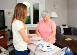 caregiver and senior woman doing some household chores